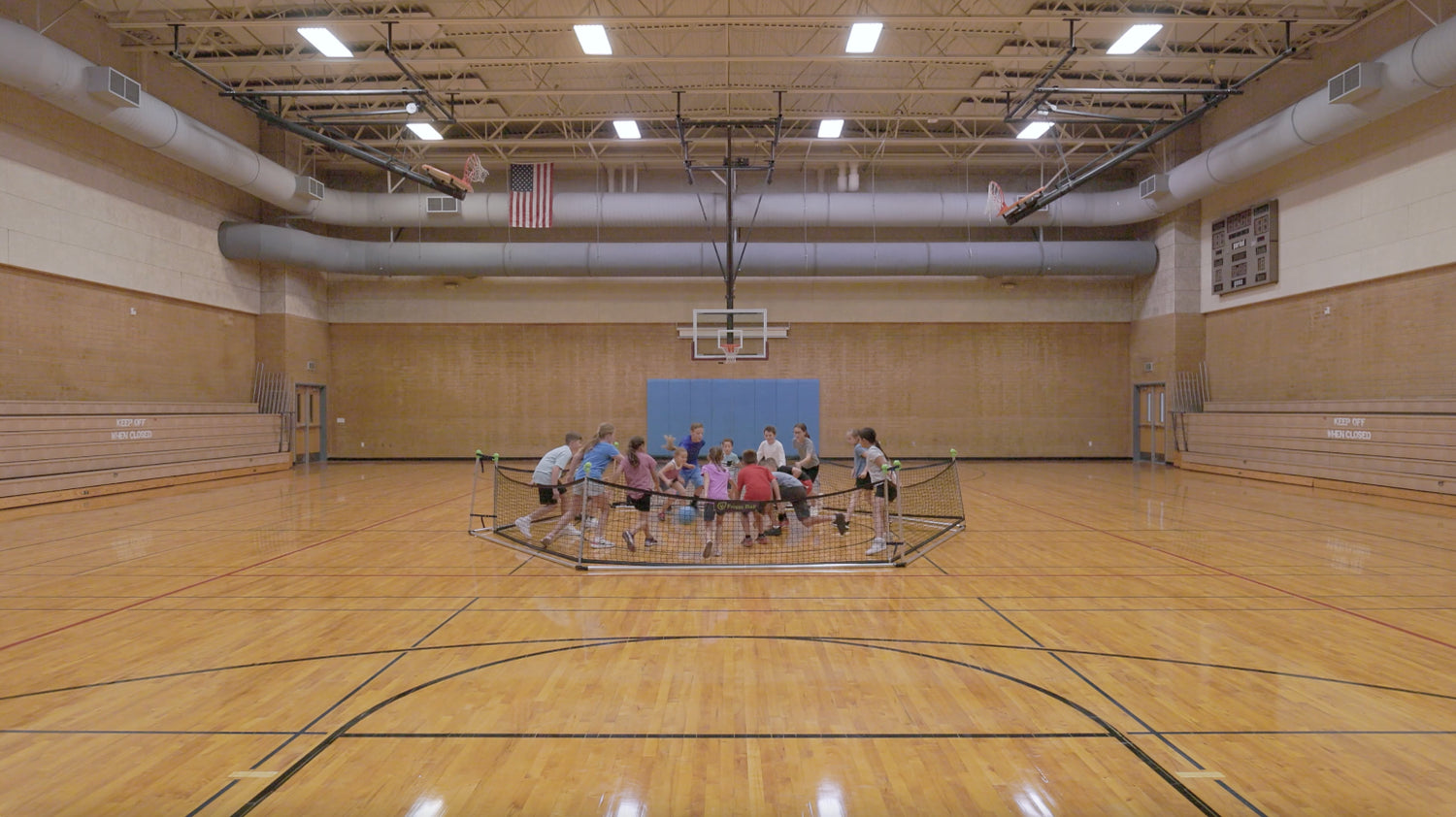 Kids playing Gaga Ball - Froggy Ball in a gym